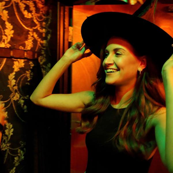 Girl Trying on Witches Hat in Escape Room at The Escapologist